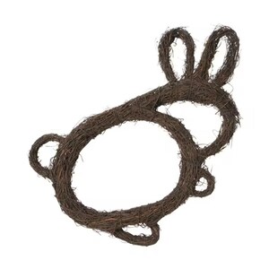 May include: A brown, twig-woven Easter bunny wreath. The wreath is shaped like a bunny with large ears and a circular body. The natural brown color of the twigs gives it a rustic, handmade appearance, perfect for spring decor.