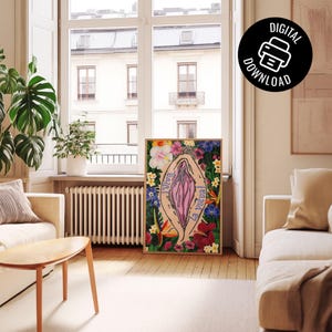 A lifestyle mockup of the art print in a thin wood frame, leaning against a wall on a light wood floor. The room is a bright, modern living area with a large window and a "Digital Download" icon in the corner.