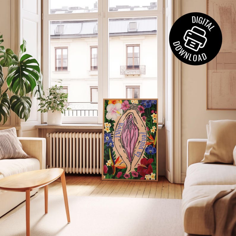 A lifestyle mockup of the art print in a thin wood frame, leaning against a wall on a light wood floor. The room is a bright, modern living area with a large window and a "Digital Download" icon in the corner.