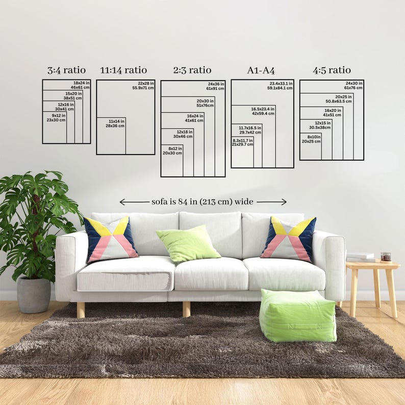A comprehensive vertical art sizing guide displayed above a white sofa. Shows various ratios including 3:4, 11:14, 2:3, A1-A4, and 4:5 to help customers choose the correct print dimensions for their space.