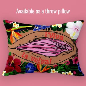 A rectangular throw pillow featuring the Viva La Vulva floral design and red/orange typography, centered against a soft pink background to show the artwork on home textiles.