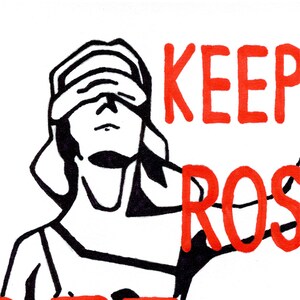 A close-up detail of the Lady Justice illustration, showing the blindfold and the "Keep Your" hand-lettered text in red, emphasizing the artistic, hand-drawn style of the piece.