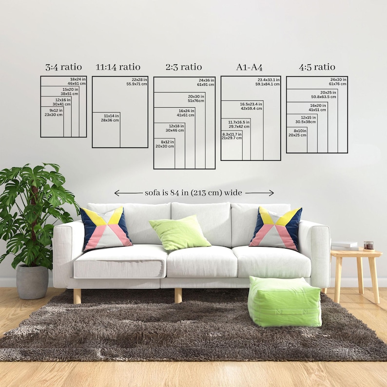A comprehensive vertical art sizing guide displayed above a white sofa. Shows various ratios including 3:4, 11:14, 2:3, A1-A4, and 4:5 to help customers choose the correct print dimensions for their space.