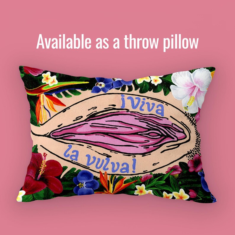 A rectangular throw pillow featuring the "Viva la Vulva" artwork. The design is oriented horizontally to fit the pillow shape, maintaining the vibrant floral border. Above it, text reads "Available as a throw pillow."
