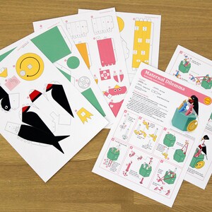 May include: A papercraft kit titled "Maternal Dilemma" with instructions and templates to build a penguin with a nest of chicks. The kit includes a green, yellow, and black color scheme.
