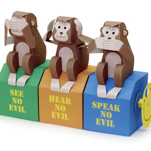 May include: Three brown paper mache monkeys, each with a different gesture, sitting on boxes. The monkey on the left has its hands over its eyes, the middle monkey has its hands over its ears, and the monkey on the right has its hands over its mouth. The boxes are labeled "See No Evil", "Hear No Evil", and "Speak No Evil".