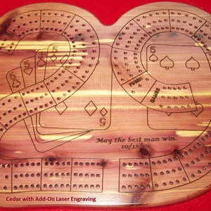 May include: A wooden cribbage board with a custom laser engraving. The board is shaped like a number 20 and has a brown wood grain. The engraving includes the text "May the best man win. 10/12/19".