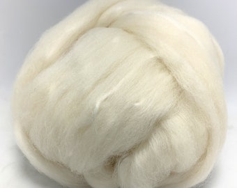 May include: A close-up of a large clump of white wool roving. The wool is soft and fluffy, and it is perfect for spinning or felting.