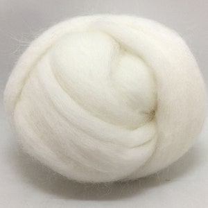 May include: A close-up of a white ball of wool fiber. The wool is soft and fluffy, and it is perfect for felting or spinning.