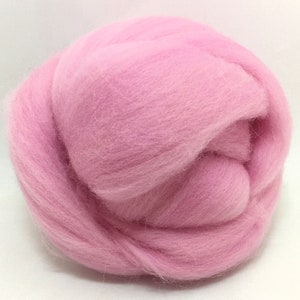 May include: A ball of pink wool roving, a type of fiber used for felting and spinning.