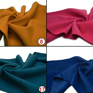 May include: Four fabric swatches in different colors: mustard yellow, pink, teal, and navy blue. The swatches are folded and arranged in a grid pattern.