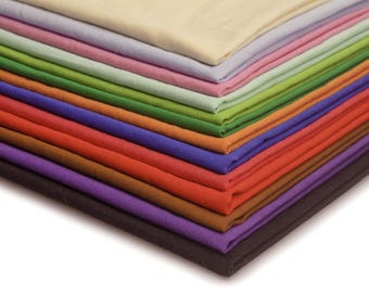 May include: A stack of fabric swatches in various colors, including beige, lavender, pink, green, orange, blue, red, brown, purple, and black.