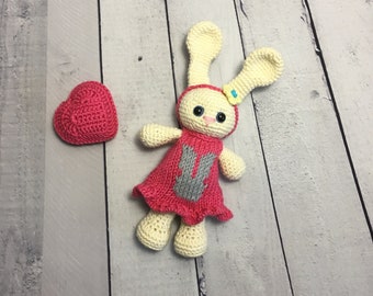 Crochet amigurumi rabbit toy in a pink dress