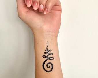 May include: A black temporary tattoo of a stylized symbol on a person's wrist. The symbol is a spiral with a series of loops above it.