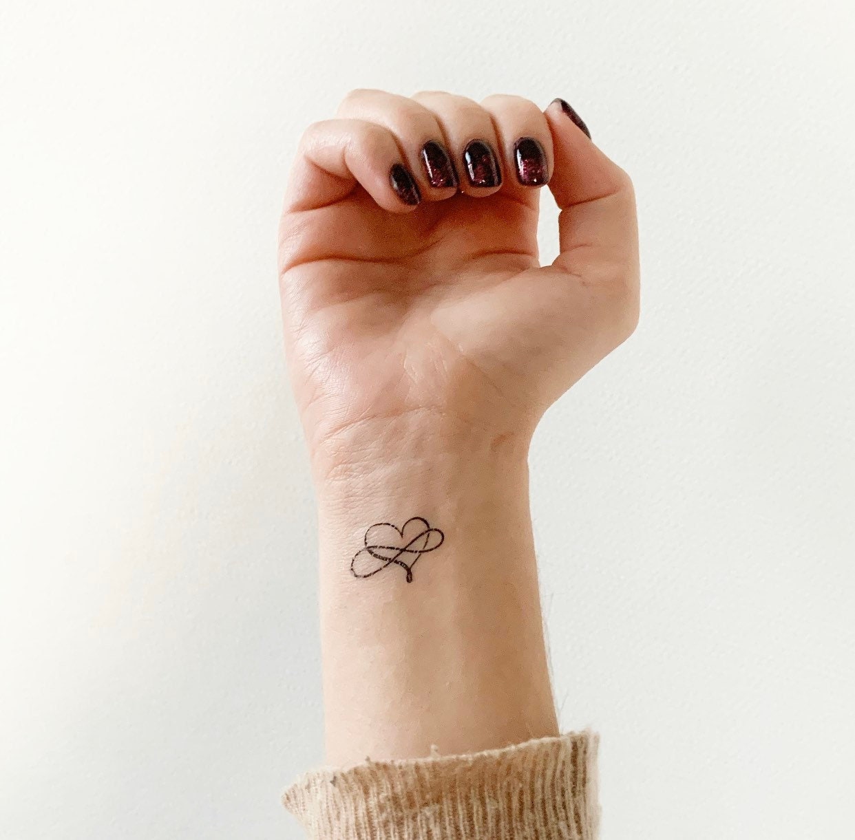 Tiny Heart Infinity Tattoo On Finger