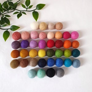 Flat lay of our colour board showing the range of felt ball colours we offer