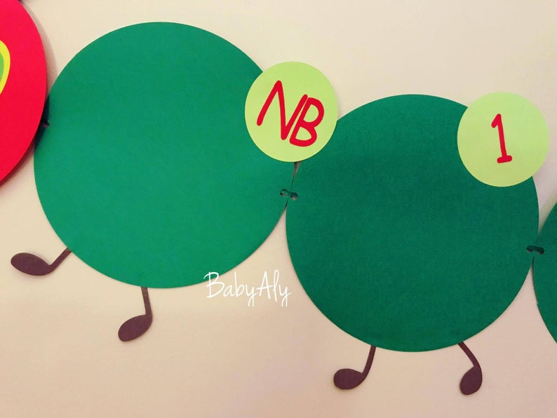May include: Green felt circles with brown felt legs and red felt numbers on yellow felt circles. The numbers are "NB" and "1".