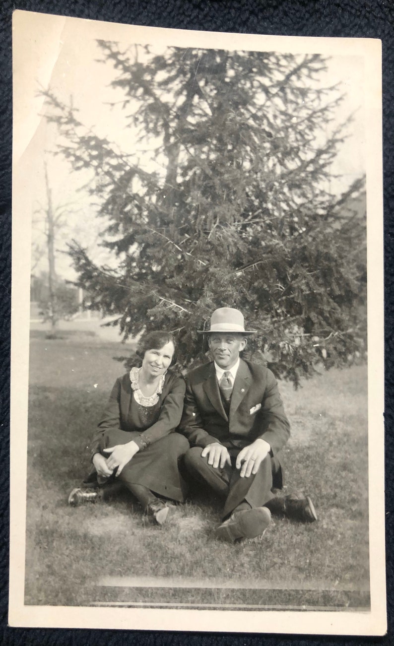 Antique Couple Sitting Under a Tree Photo