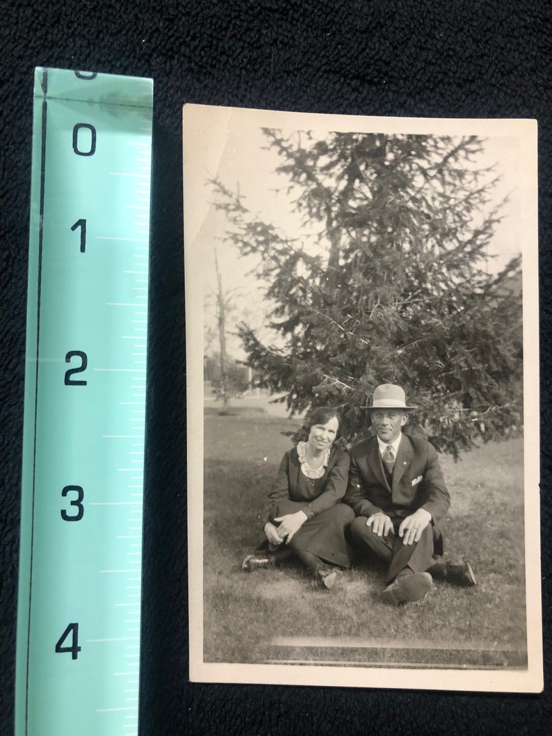 Antique Couple Sitting Under a Tree Photo