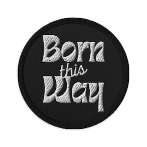May include: A black round patch with white embroidered text that reads "Born this Way".