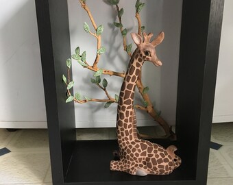 Majestic giraffe hidden in its recycled setting. She loves company