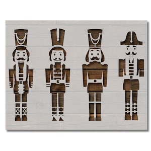 May include: A wooden wall art piece featuring four stylized nutcracker figures in a row. The nutcrackers are brown with white accents, set against a light gray, wood-grain background. The artwork evokes a festive, holiday theme.