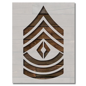 May include: A white stencil of a military rank insignia, featuring chevrons and a diamond shape, set against a wooden plank background. The design is a cut-out, revealing the wood grain beneath. The overall aesthetic is rustic and military-themed.