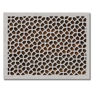 May include: A white stencil with a repeating geometric pattern, set against a brown wood grain background. The stencil's design features interconnected, rounded shapes, creating a lattice effect. The stencil is framed by a white border.