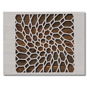 May include: A white, geometric pattern stencil over a wooden background. The stencil features a repeating, interconnected design of irregular shapes. The wooden background has a natural, brown color, and the stencil is set against a white, wooden-planked frame.