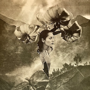May include: A black and white photo of a woman with flowers in her hair. The woman is looking to the side and her hand is resting on her chest. The background is a blurry image of a mountain landscape.