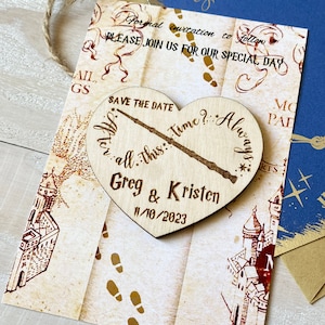 May include: A wooden heart-shaped save the date magnet with a wand and the text "After all this time? Always."  The magnet also includes the names Greg & Kristen and the date 11/10/2023. The magnet is on top of a parchment-like background with a map of Hogwarts.