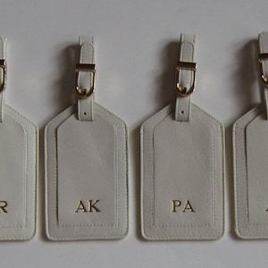 Monogrammed Genuine Leather Luggage Tags with initials or names.
We offer gold and silver buckles.
There is a pocket under the flap to keep your personal information.