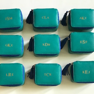 Personalized Genuine Leather Travel Jewelry Organizer with initials.
Small zip around leather jewelry box. 3 Interior pockets for rings/pendants or necklaces. 
Top inside flap with 2 snap leather straps for 3 to 5 pairs earrings.