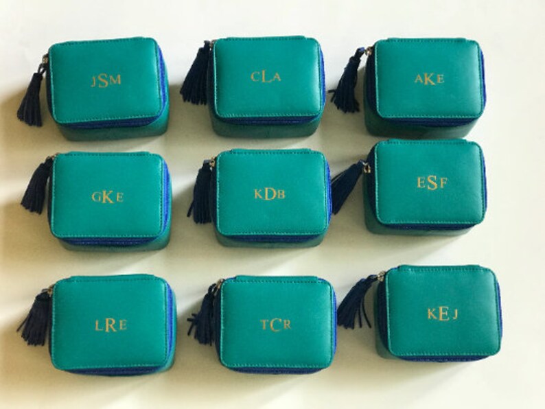 Personalized Genuine Leather Travel Jewelry Organizer with initials.
Small zip around leather jewelry box. 3 Interior pockets for rings/pendants or necklaces. 
Top inside flap with 2 snap leather straps for 3 to 5 pairs earrings.