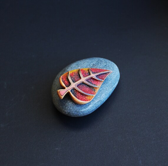 Miniature original paintings worn as brooches — each wooden pin is a one-of-a-kind wearable canvas, not a print.