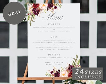 Op de afbeelding: Een huwelijksmenu-bord met een bloemmotief in tinten bordeauxrood, roze en wit. Het menu bevat voorgerecht-, hoofdgerecht- en dessert-opties. De tekst onderaan luidt "Amelia & Oliver August 30, 2022" en "24 maten inbegrepen".