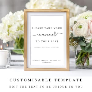 May include: A gold-framed sign with white background and black text that reads "Please take your name card to your seat so we know what you are having to eat. Charlotte & Brandon 19th October 2017 #KNOWLES2017".