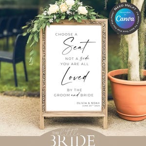 May include: Wooden framed wedding sign with the text "Choose a Seat, Not a Side, You Are All Loved, By The Groom and Bride." The sign is decorated with flowers and greenery. The sign is for Olivia & Noah, June 20th, 2029.