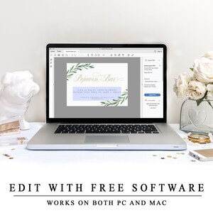 May include: A laptop computer screen displaying a printable sign for a popcorn bar. The sign has a watercolour background with green leaves and the text "Popcorn Bar" in gold script. The text below reads "Life is salty, love is sweet, please feel free to take a treat".