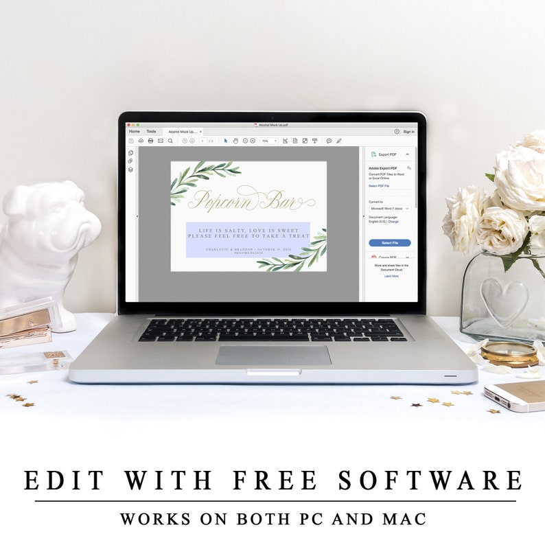 May include: A laptop computer screen displaying a printable sign for a popcorn bar. The sign has a watercolour background with green leaves and the text "Popcorn Bar" in gold script. The text below reads "Life is salty, love is sweet, please feel free to take a treat".