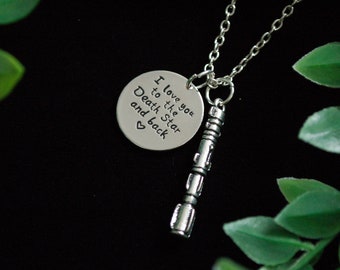 May include: Silver necklace with a round pendant that says "I love you to the Death Star and back" with a heart symbol. The necklace also has a silver charm that looks like a sonic screwdriver.