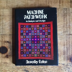 May include: A book titled "MACHINE PATCHWORK techniques and design" by Dorothy Osler. The cover is black with white text and a colourful patchwork quilt design in red, blue, purple, and orange.