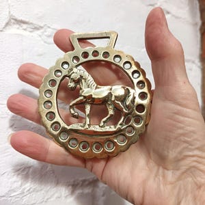 Trotting horse, cast horse brass with punched holes border. A handsome old piece of decorative harness wear.