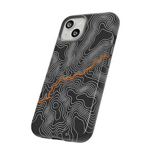 May include: Black phone case with a topographic map design. The case features a pattern of white contour lines over a dark background, with an orange line accent. The case has cutouts for the phone's camera.