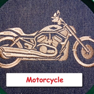 May include: Embroidered image of a motorcycle on a blue denim background. The motorcycle is outlined in a copper color and the word "Motorcycle" is written in red below the image.