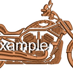 May include: A brown motorcycle with a single seat and a large engine. The motorcycle has a chrome exhaust pipe and a large front wheel.