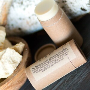 May include: A brown cardboard tube with a white label containing instructions for use. The label reads "To Uses Push up gently from base Refrate to harden if product melts or becomes soft store in a cool, dry place. Do not apply to broken skin. Discontinue use if irritation occurs. Use within 6 months of purchases".