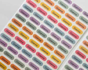May include: A sheet of colorful oval stickers with the name "Gianna" printed on each sticker. The stickers are in various colors, including purple, green, yellow, orange, and blue.