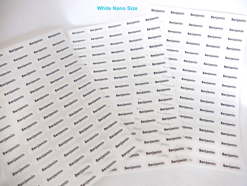May include: A sheet of white, transparent labels with the name "Benjamin" printed in black on each label. The labels are in a nano size and are arranged in rows and columns.