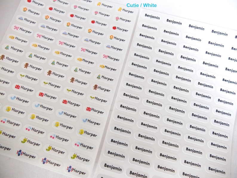 May include: A sheet of white, oval-shaped name labels with a variety of cute illustrations. The labels are printed with the names "Harper" and "Benjamin" in black text.